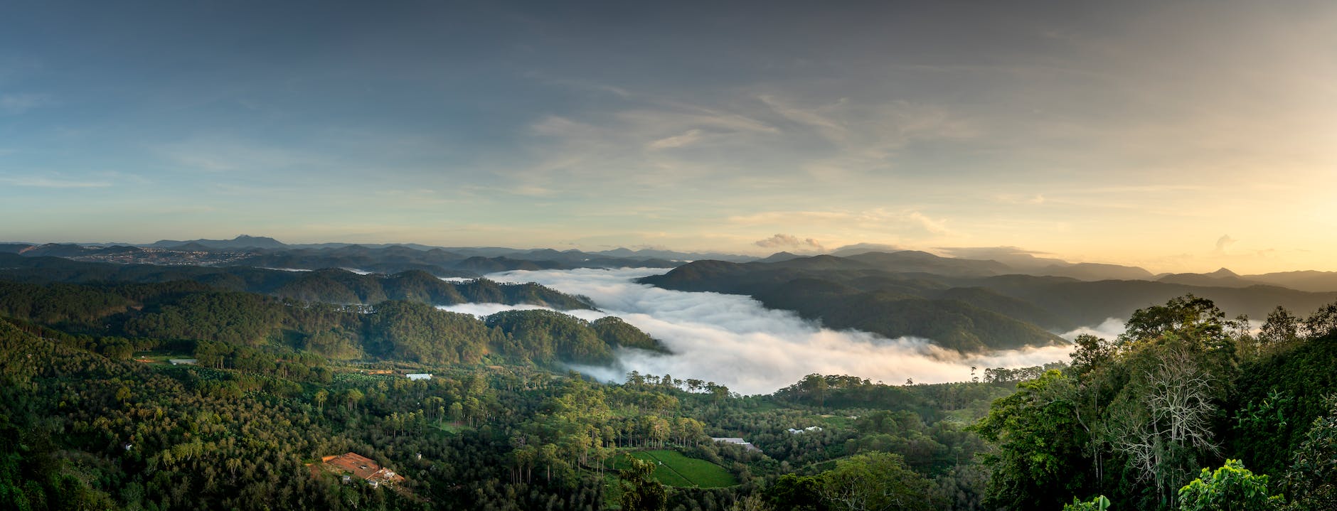 scenic landscape of hilly terrain covered with lush tropical vegetation at sundown