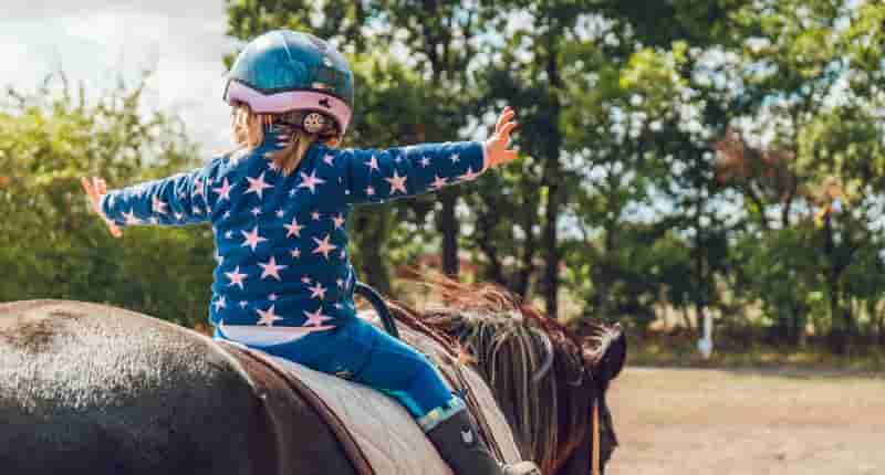 girl riding black horse