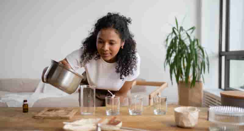 woman in white shirt holding a cooking pot