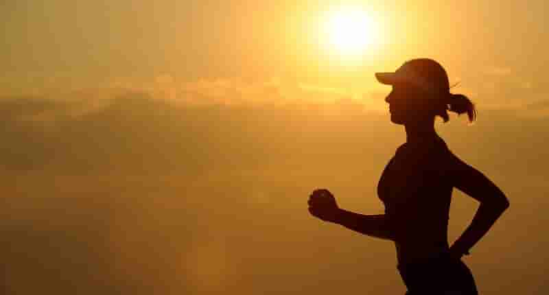 woman with white sunvisor running