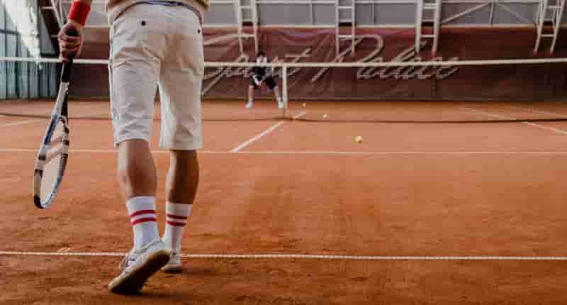 people playing tennis on the tennis clay court