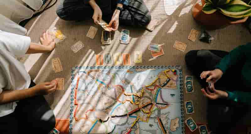 person in black shirt and black pants sitting on brown and blue rug