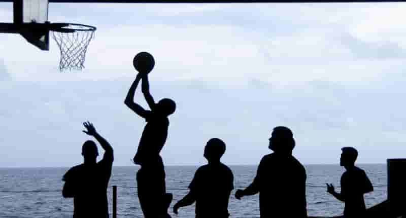 silhouette of men playing basketball