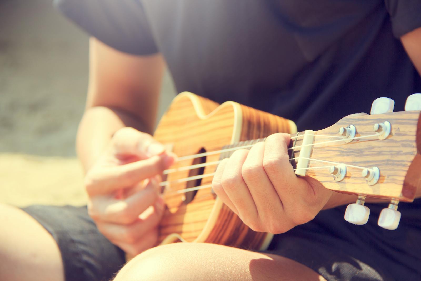 Person Playing Ukulele