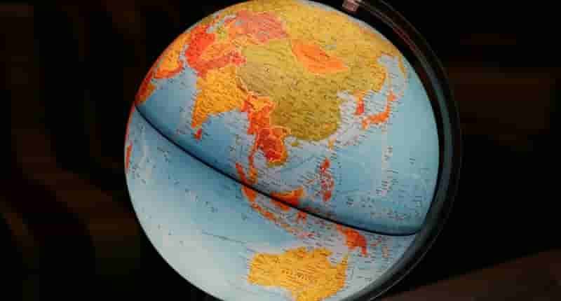 A vibrant illuminated globe showcasing Earth's continents in a dark setting, ideal for educational and decor purposes.
