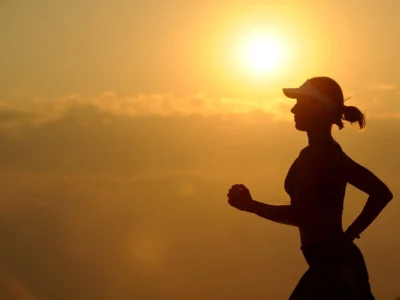 woman with white sunvisor running
