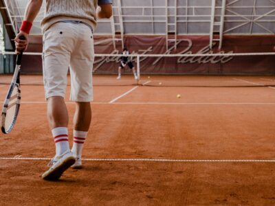 people playing tennis on the tennis clay court
