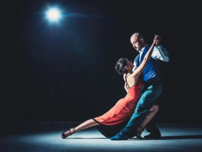woman and man dancing under light