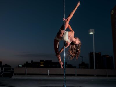 woman in white bikini doing pole dancing