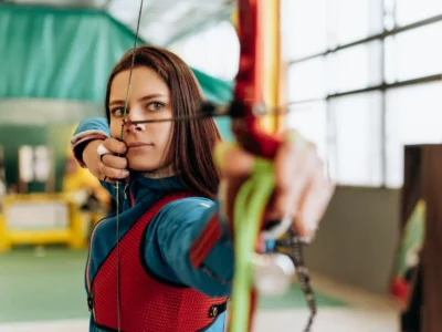 beautiful woman shooting a bow and arrow