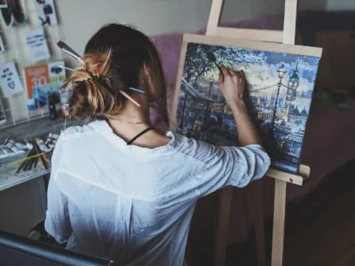 photo of woman in front of painting