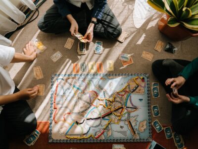 person in black shirt and black pants sitting on brown and blue rug