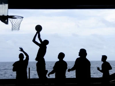 silhouette of men playing basketball