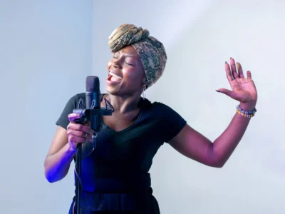 photo of woman singing in music studio