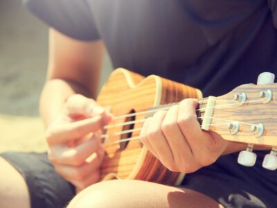 Person Playing Ukulele