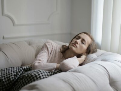 Girl in White Sweater Lying on Couch