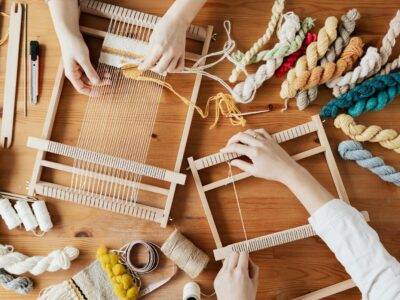 Top View Photo of Two Person's Hands Weaving