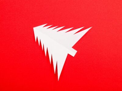 Christmas Tree Shaped Paper on Red Background